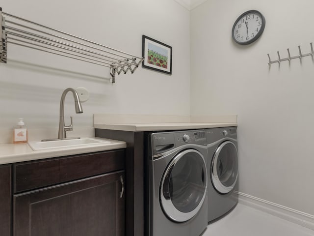 8784 Lewis River Rd, Delray Beach, FL 33446 - washroom with washing machine and clothes dryer, crown molding, baseboards, and cabinet space