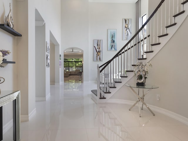 8784 Lewis River Rd, Delray Beach, FL 33446 - foyer with a high ceiling, baseboards, stairway, and tile patterned flooring