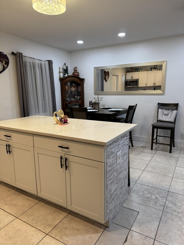 1413 S C Ter S, Lake Worth, FL 33460 - kitchen with stainless steel microwave, light countertops, light tile patterned floors, and recessed lighting