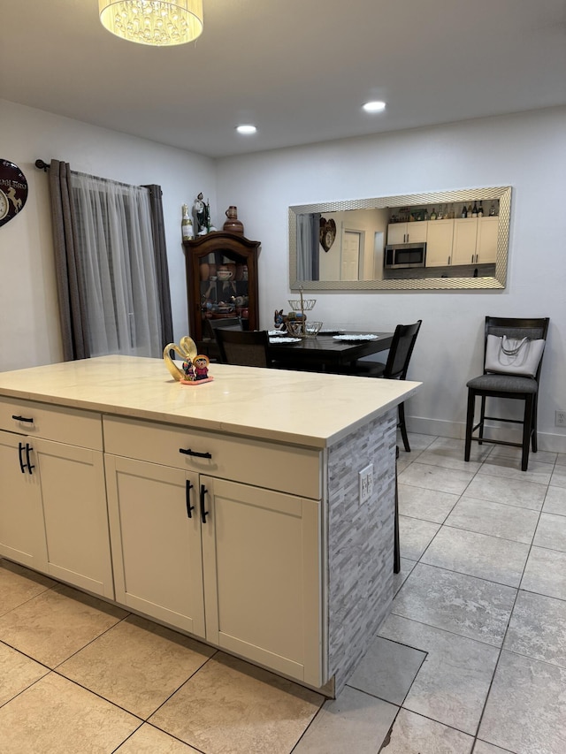 1413 S C Ter S, Lake Worth, FL 33460 - kitchen with stainless steel microwave, light countertops, light tile patterned floors, and recessed lighting