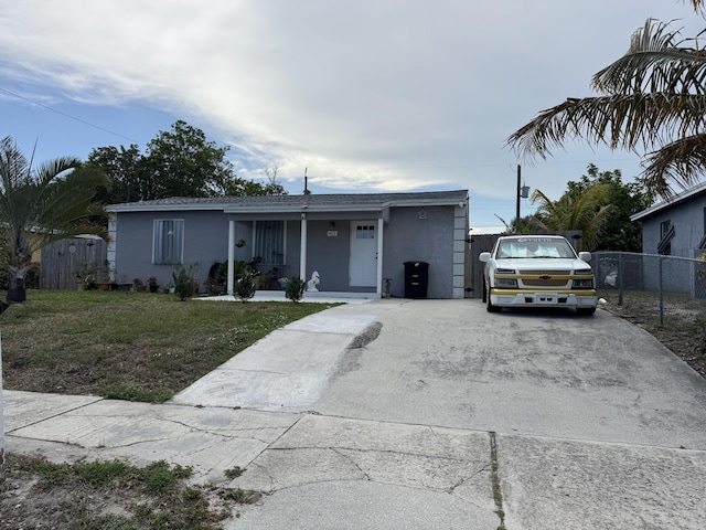 1413 S C Ter S, Lake Worth, FL 33460 - single story home with stucco siding, driveway, a porch, and a gate