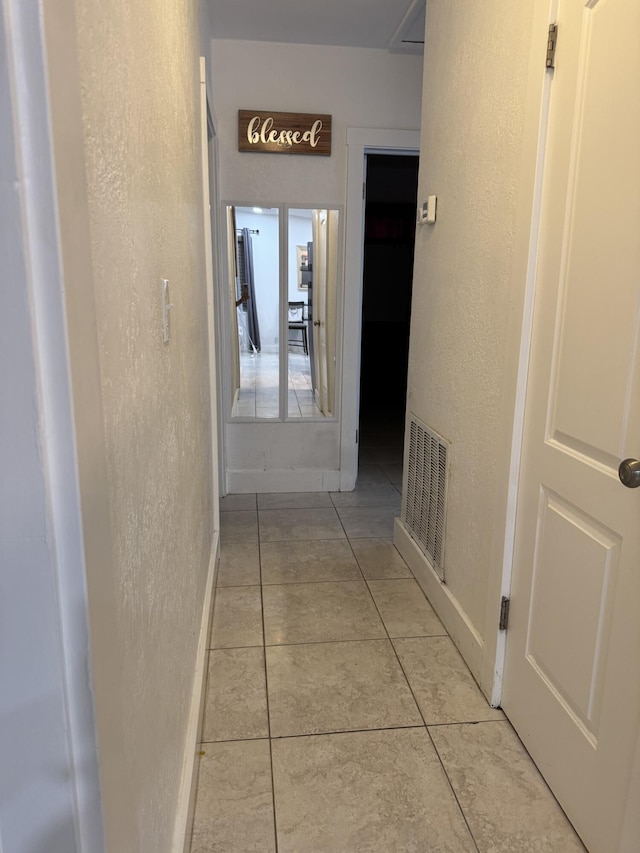 1413 S C Ter S, Lake Worth, FL 33460 - corridor with a textured wall, light tile patterned floors, and baseboards