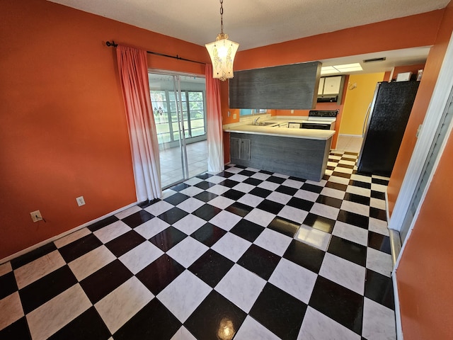 389 SE Tranquilla Ave, Port Saint Lucie, FL 34983 - kitchen featuring range with electric cooktop, a peninsula, a chandelier, light countertops, and a sink