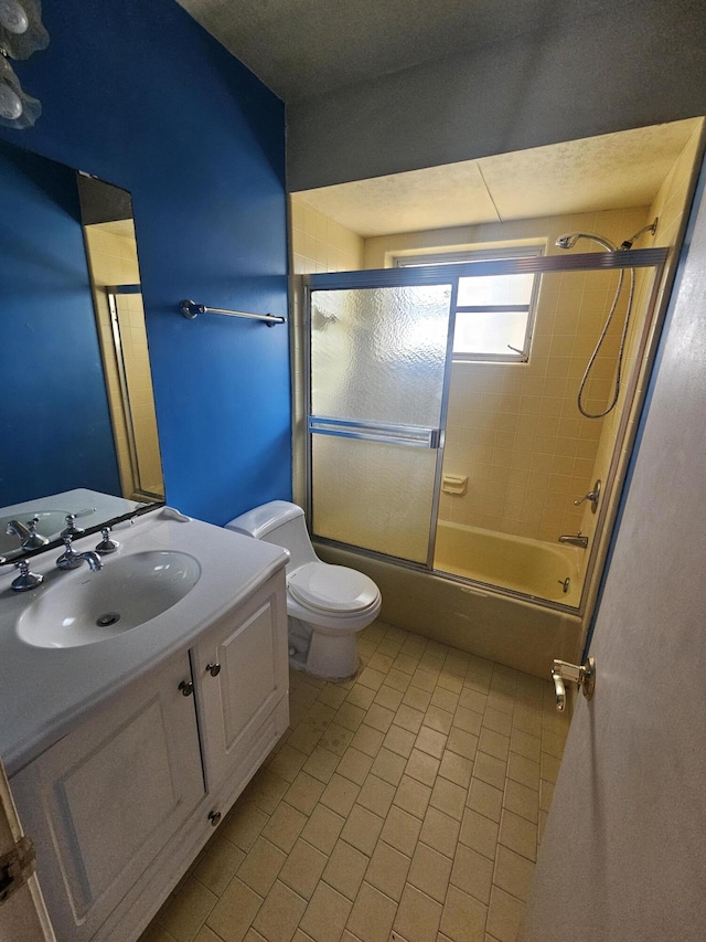 389 SE Tranquilla Ave, Port Saint Lucie, FL 34983 - full bathroom with tile patterned flooring, vanity, toilet, and bath / shower combo with glass door