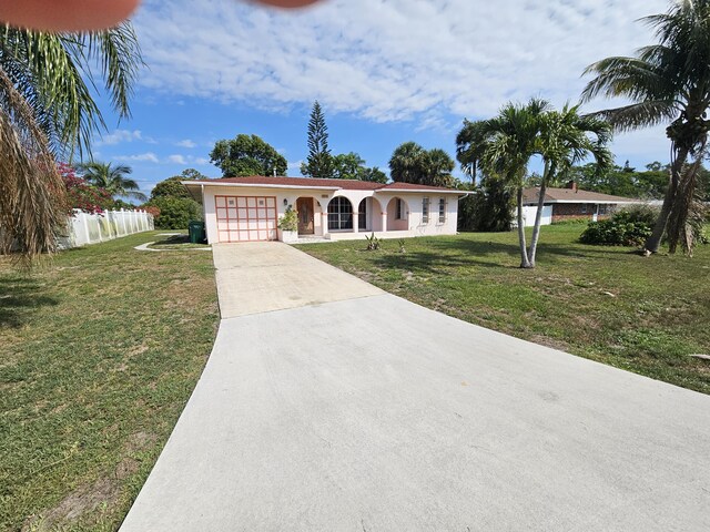 389 SE Tranquilla Ave, Port Saint Lucie, FL 34983 - single story home with an attached garage, concrete driveway, and stucco siding