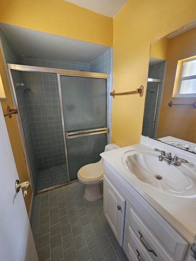 389 SE Tranquilla Ave, Port Saint Lucie, FL 34983 - bathroom featuring toilet, vanity, tile patterned flooring, and a shower stall