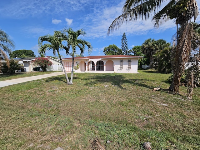 389 SE Tranquilla Ave, Port Saint Lucie, FL 34983 - single story home with driveway, stucco siding, and a front yard