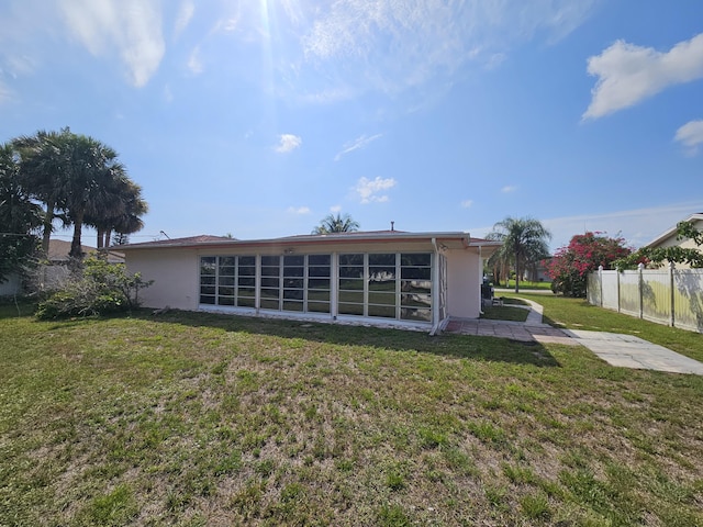 389 SE Tranquilla Ave, Port Saint Lucie, FL 34983 - back of property with stucco siding and a sunroom
