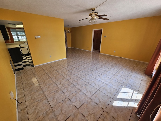 389 SE Tranquilla Ave, Port Saint Lucie, FL 34983 - empty room featuring a ceiling fan, a textured ceiling, a chandelier, and a sink