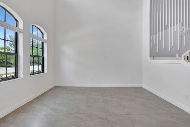 8660 W Parkland Bay Trl, Parkland, FL 33076 - empty room featuring baseboards and a towering ceiling