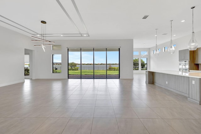 8660 W Parkland Bay Trl, Parkland, FL 33076 - unfurnished living room with recessed lighting, light tile patterned floors, a sink, and baseboards