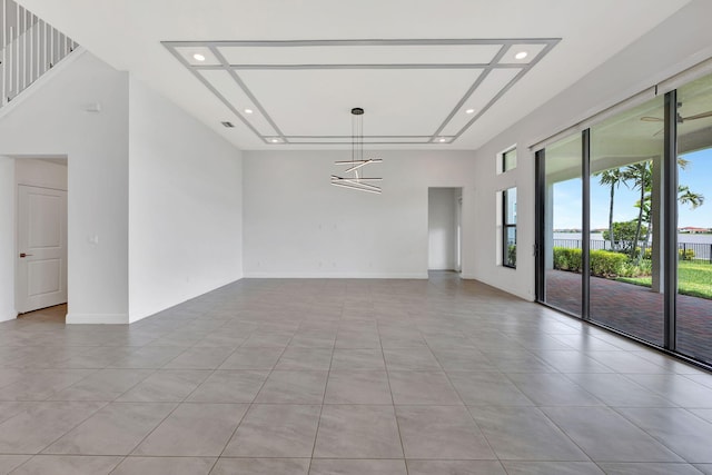 8660 W Parkland Bay Trl, Parkland, FL 33076 - empty room with light tile patterned floors, recessed lighting, baseboards, and a towering ceiling