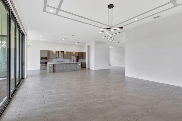 8660 W Parkland Bay Trl, Parkland, FL 33076 - unfurnished living room with a chandelier