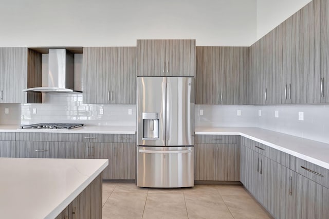 8660 W Parkland Bay Trl, Parkland, FL 33076 - kitchen featuring appliances with stainless steel finishes, wall chimney range hood, light countertops, decorative backsplash, and gray cabinetry