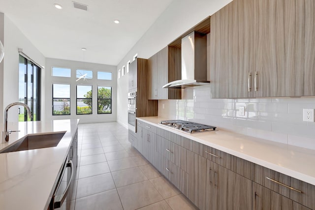 8660 W Parkland Bay Trl, Parkland, FL 33076 - kitchen with wall chimney exhaust hood, appliances with stainless steel finishes, a sink, tasteful backsplash, and healthy amount of natural light