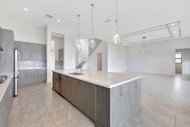 8660 W Parkland Bay Trl, Parkland, FL 33076 - kitchen featuring a sink, stainless steel appliances, light tile patterned flooring, open floor plan, and modern cabinets