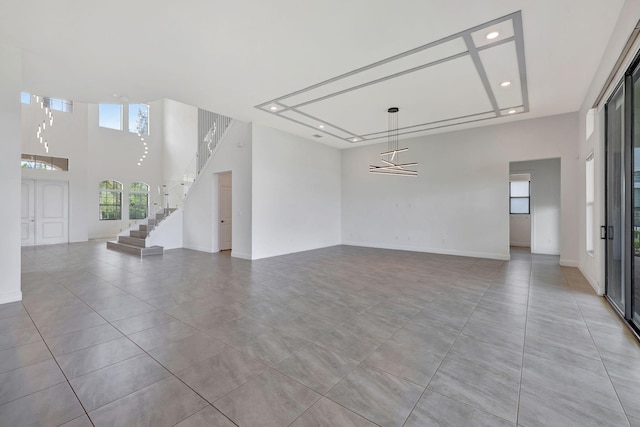 8660 W Parkland Bay Trl, Parkland, FL 33076 - spare room with recessed lighting, a towering ceiling, stairs, light tile patterned flooring, and baseboards