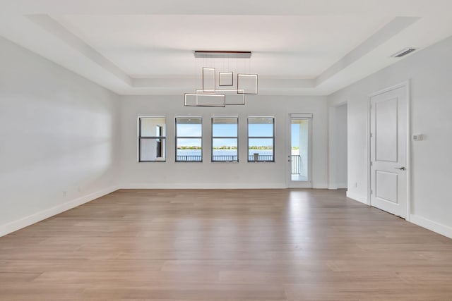 8660 W Parkland Bay Trl, Parkland, FL 33076 - unfurnished room featuring a raised ceiling, light wood finished floors, and baseboards