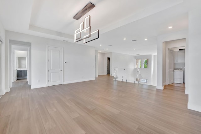 8660 W Parkland Bay Trl, Parkland, FL 33076 - unfurnished living room with washer / dryer, light wood-style floors, baseboards, and recessed lighting