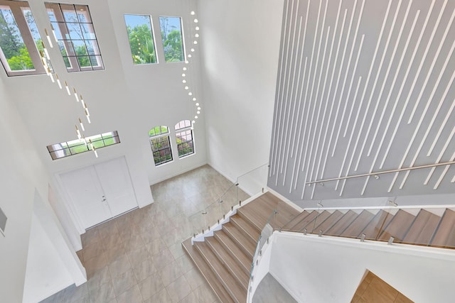 8660 W Parkland Bay Trl, Parkland, FL 33076 - entrance foyer with healthy amount of natural light, a towering ceiling, and tile patterned floors