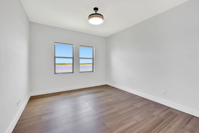 8660 W Parkland Bay Trl, Parkland, FL 33076 - spare room featuring baseboards and wood finished floors