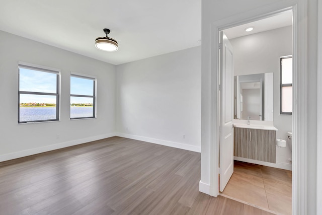 8660 W Parkland Bay Trl, Parkland, FL 33076 - unfurnished room featuring wood finished floors, baseboards, and a sink