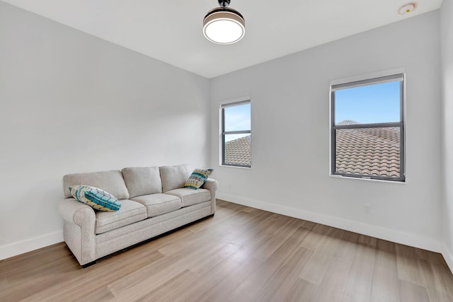8660 W Parkland Bay Trl, Parkland, FL 33076 - living room featuring baseboards and light wood-style flooring