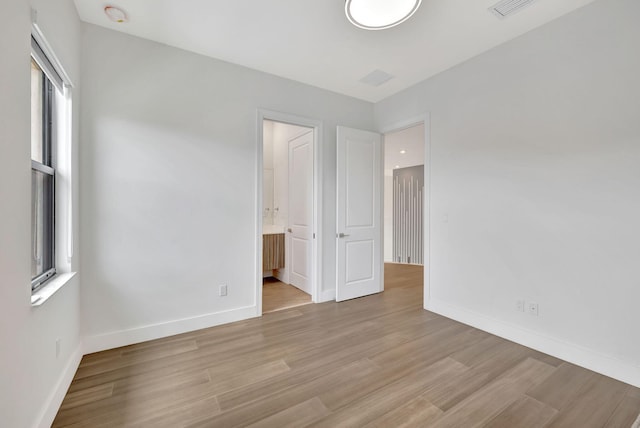 8660 W Parkland Bay Trl, Parkland, FL 33076 - empty room with light wood-type flooring, healthy amount of natural light, baseboards, and a smoke detector