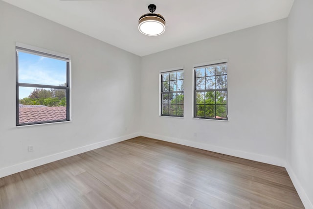 8660 W Parkland Bay Trl, Parkland, FL 33076 - empty room with baseboards and wood finished floors