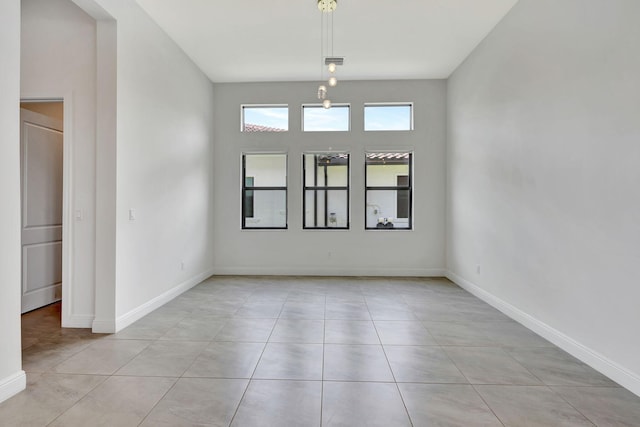 8660 W Parkland Bay Trl, Parkland, FL 33076 - empty room featuring light tile patterned flooring and baseboards