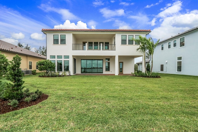 8660 W Parkland Bay Trl, Parkland, FL 33076 - rear view of house with stucco siding, a balcony, a lawn, and a tiled roof