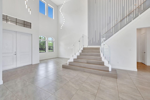 8660 W Parkland Bay Trl, Parkland, FL 33076 - tiled entryway with a high ceiling, stairs, and baseboards