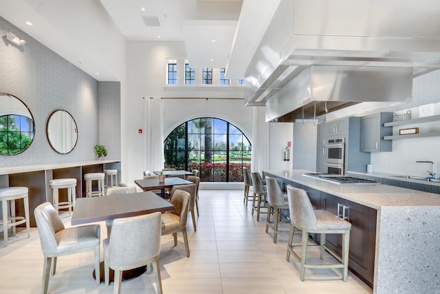 8660 W Parkland Bay Trl, Parkland, FL 33076 - dining area featuring a towering ceiling and light tile patterned floors