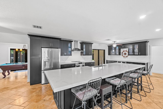 977 W Royal Palm Rd, Boca Raton, FL 33486 - kitchen featuring appliances with stainless steel finishes, a sink, wall chimney range hood, glass insert cabinets, and a large island