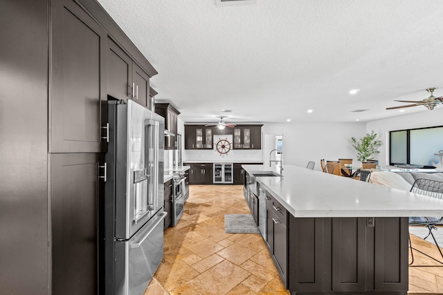 977 W Royal Palm Rd, Boca Raton, FL 33486 - kitchen featuring ceiling fan, high quality fridge, stone tile floors, a breakfast bar, and recessed lighting