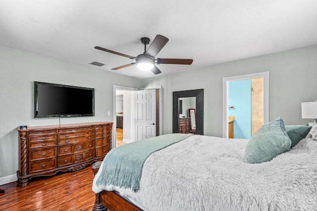 977 W Royal Palm Rd, Boca Raton, FL 33486 - bedroom with wood finished floors, baseboards, a ceiling fan, and connected bathroom