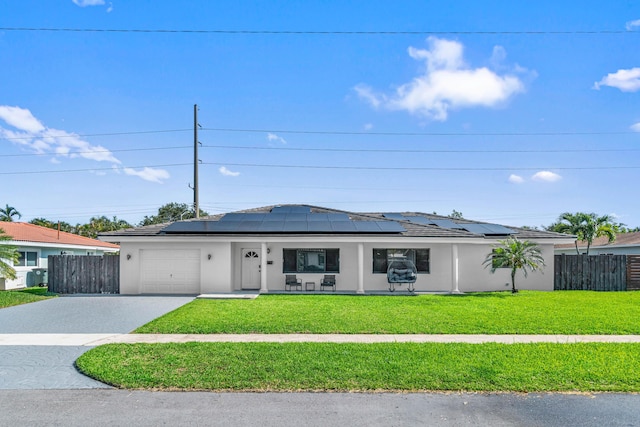 977 W Royal Palm Rd, Boca Raton, FL 33486 - single story home with an attached garage, concrete driveway, stucco siding, and roof mounted solar panels