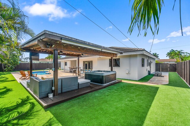 977 W Royal Palm Rd, Boca Raton, FL 33486 - back of property with a hot tub, stucco siding, a wooden deck, french doors, and a patio area