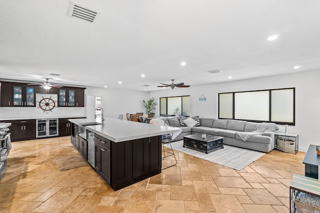 977 W Royal Palm Rd, Boca Raton, FL 33486 - kitchen with ceiling fan, stone tile flooring, a sink, wine cooler, and recessed lighting