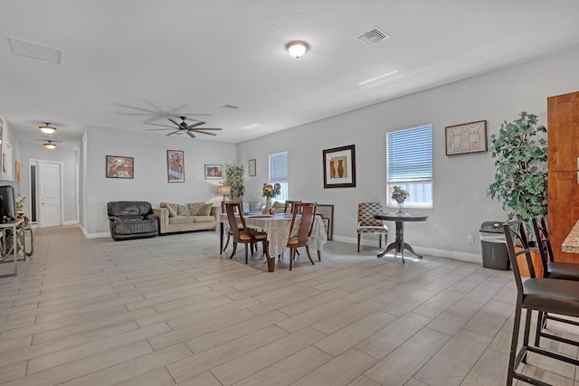 309 NE 11th Ave, Boynton Beach, FL 33435 - dining space with ceiling fan, baseboards, and light wood finished floors