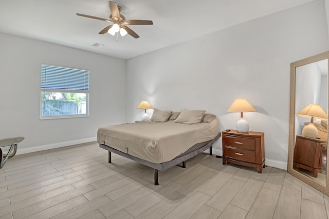309 NE 11th Ave, Boynton Beach, FL 33435 - bedroom with baseboards, light wood-style flooring, and a ceiling fan