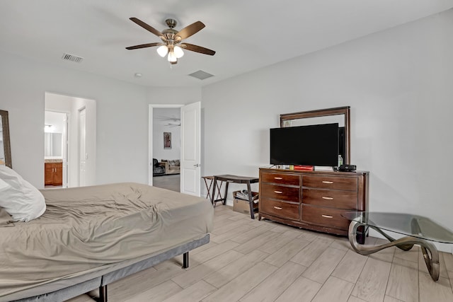 309 NE 11th Ave, Boynton Beach, FL 33435 - bedroom with light wood-style flooring, a ceiling fan, and ensuite bath