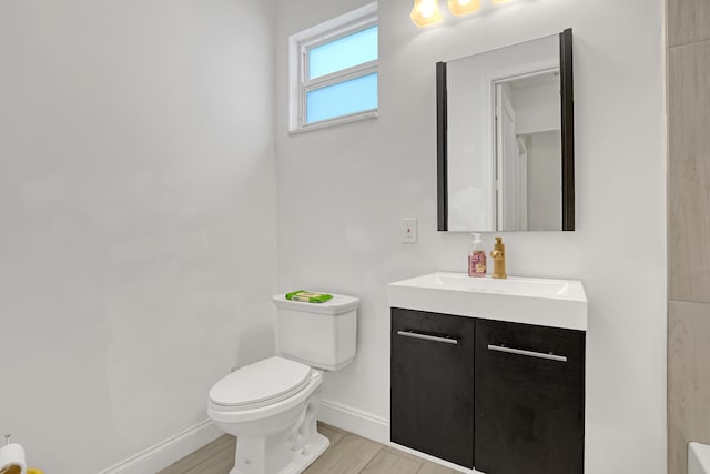309 NE 11th Ave, Boynton Beach, FL 33435 - bathroom with baseboards, vanity, toilet, and wood finished floors