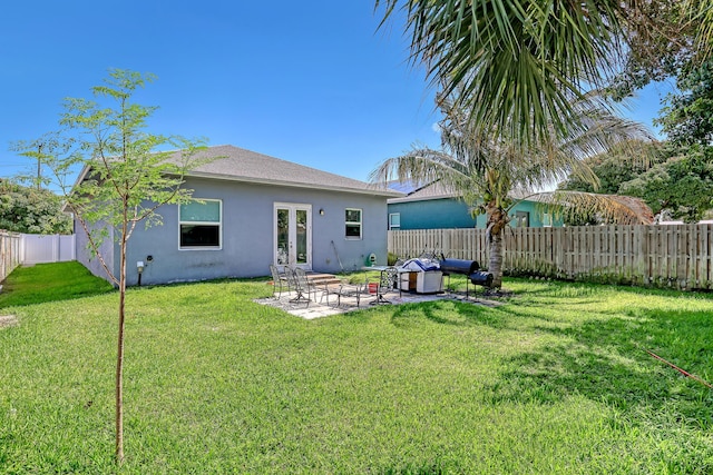 309 NE 11th Ave, Boynton Beach, FL 33435 - rear view of house with stucco siding, a patio, and french doors