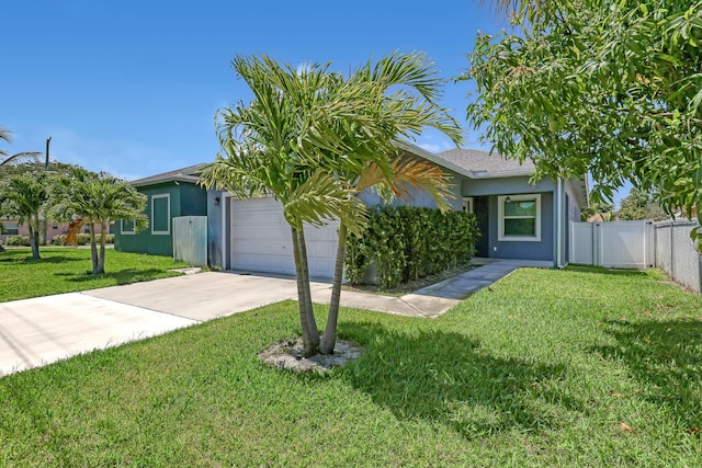 309 NE 11th Ave, Boynton Beach, FL 33435 - view of property hidden behind natural elements featuring driveway, a garage, and stucco siding