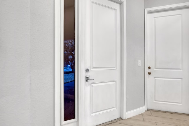 309 NE 11th Ave, Boynton Beach, FL 33435 - doorway to outside featuring wood tiled floors and baseboards
