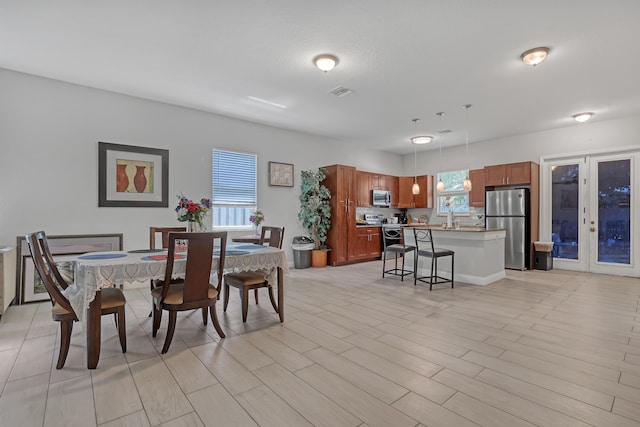 309 NE 11th Ave, Boynton Beach, FL 33435 - dining room featuring french doors and light wood-type flooring