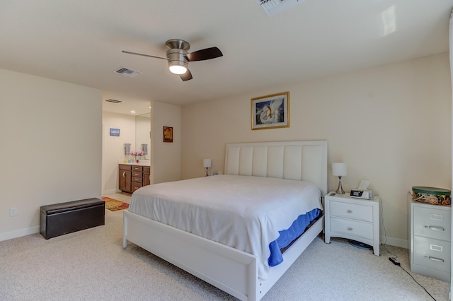 29 Mediterranean Blvd W, Port Saint Lucie, FL 34952 - bedroom with light colored carpet, baseboards, and ensuite bath