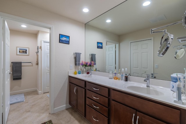 29 Mediterranean Blvd W, Port Saint Lucie, FL 34952 - full bathroom with double vanity, recessed lighting, baseboards, and tile patterned floors