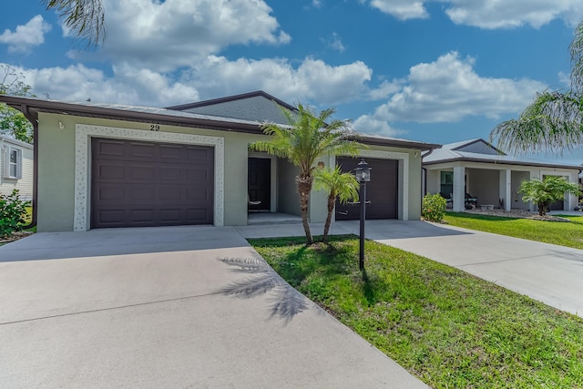 29 Mediterranean Blvd W, Port Saint Lucie, FL 34952 - single story home featuring concrete driveway, a garage, stucco siding, and a front yard